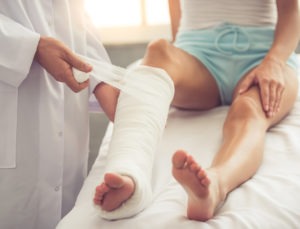 woman getting leg bandaged