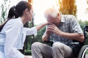 doctor comforting an older man