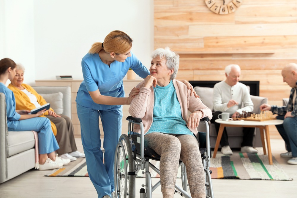 nurses assisting elderly people in retirement home