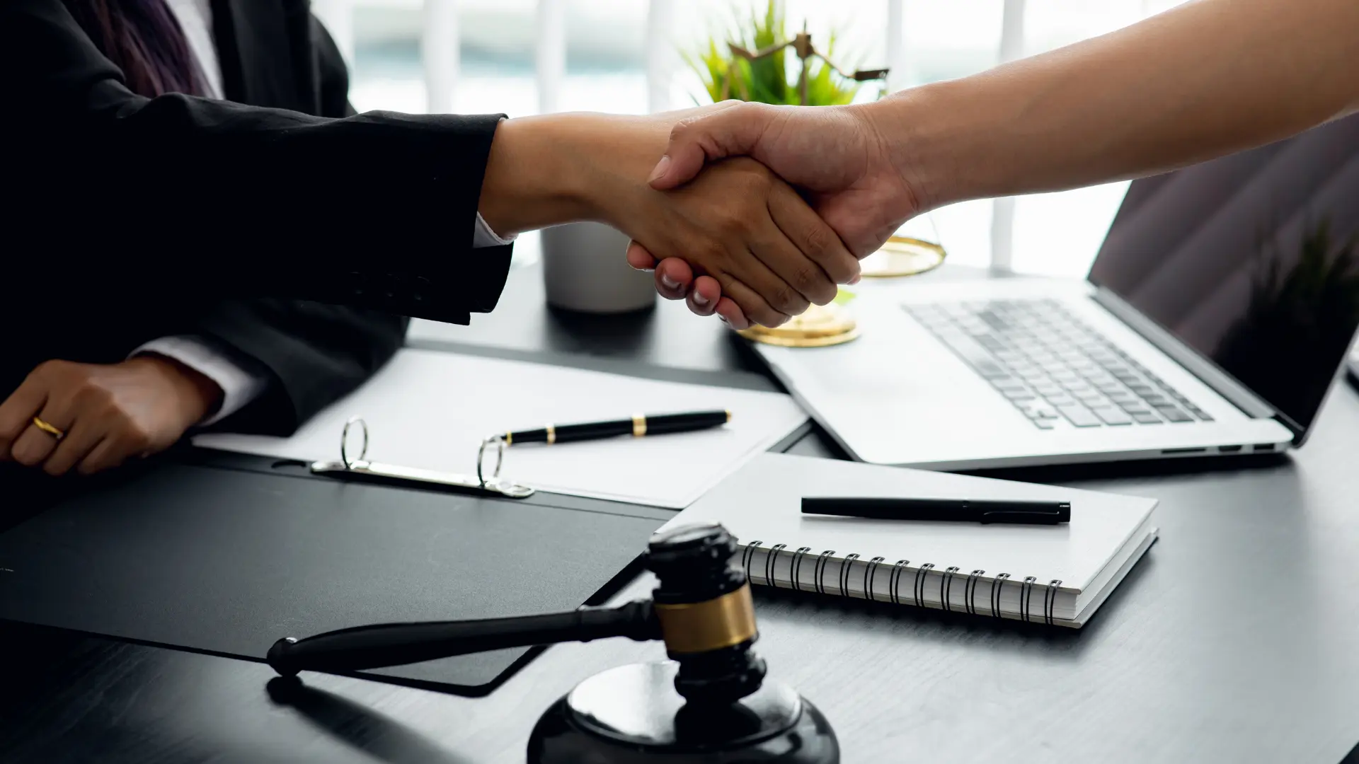 a lawyer and a client shake hands