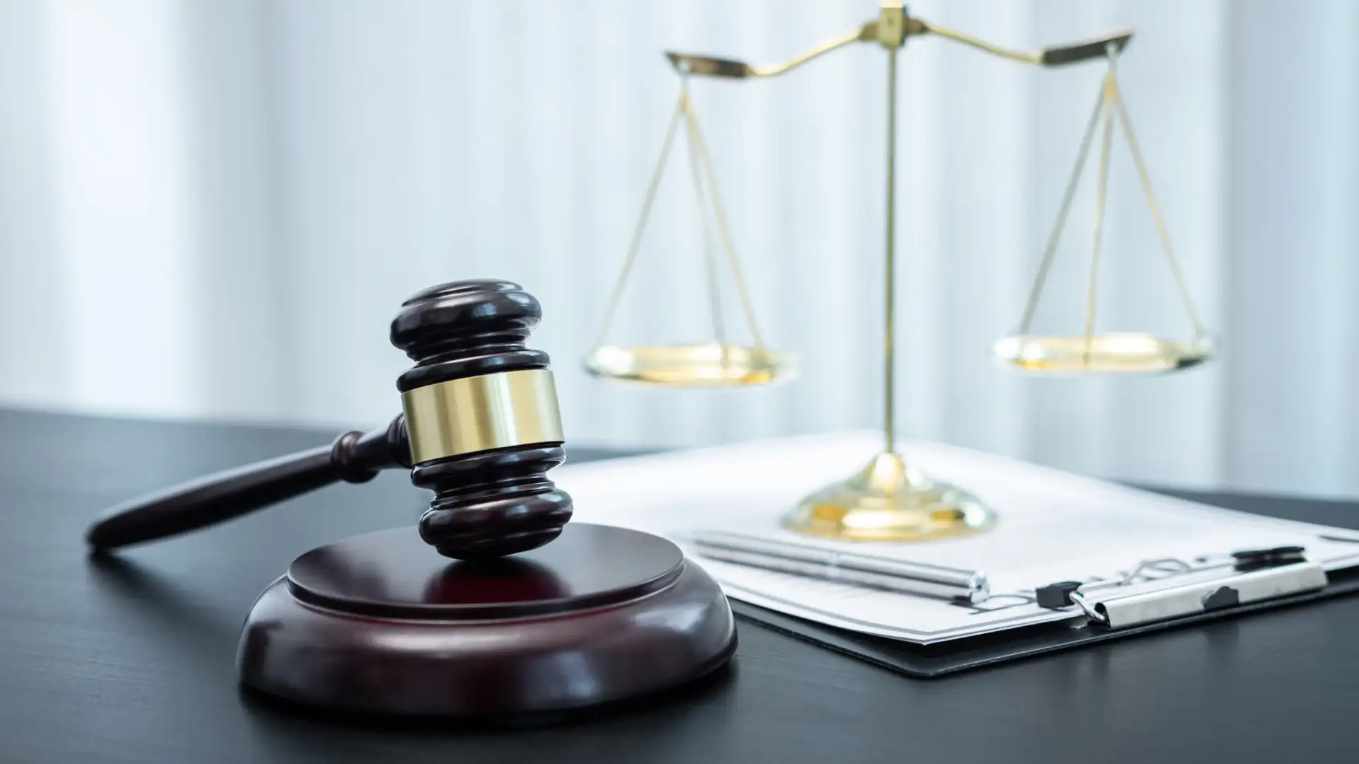 A judge's gavel and scales of justice on a desk, symbolizing legal proceedings related to amusement park injuries