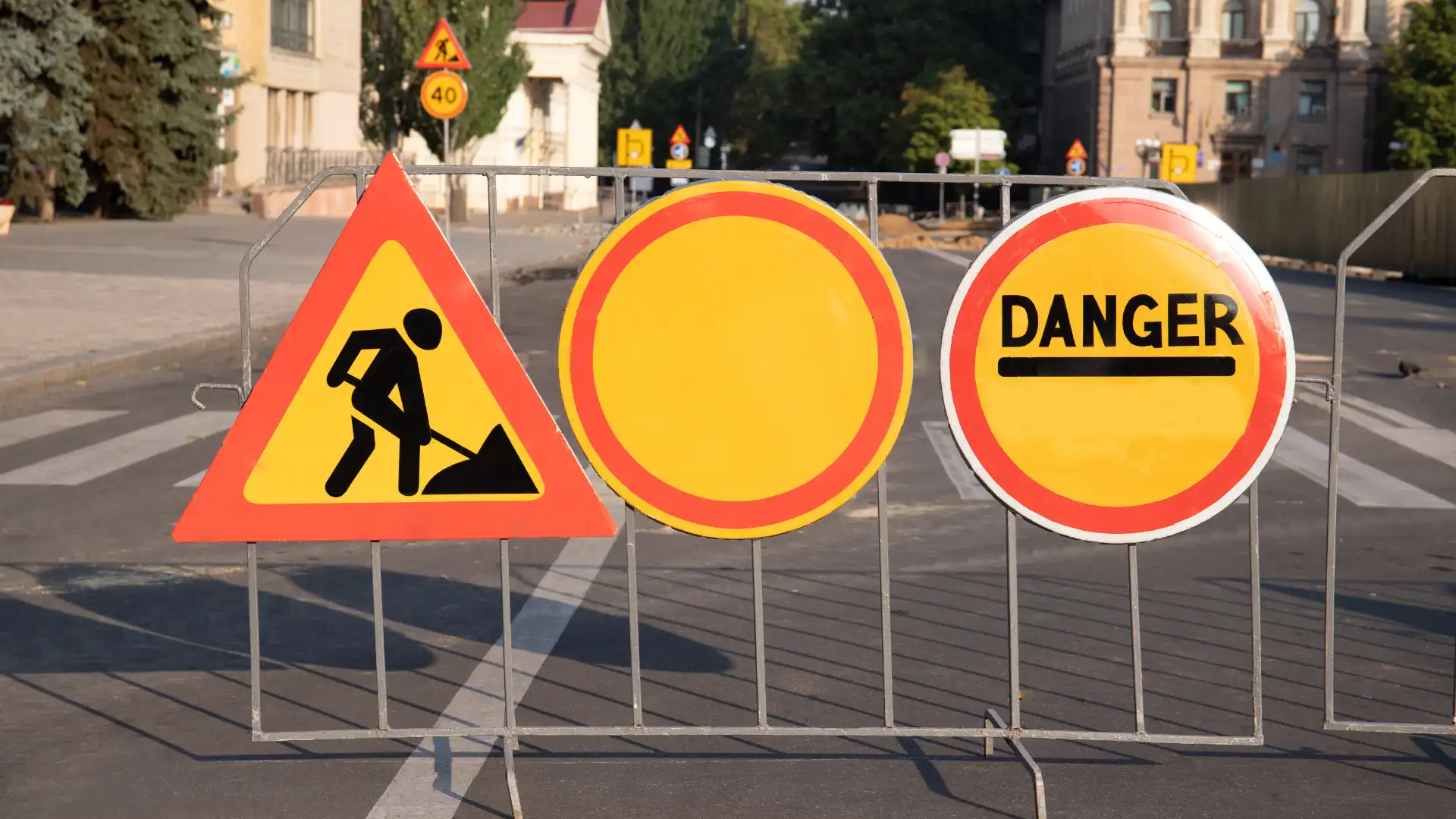 Road construction and danger signs blocking street