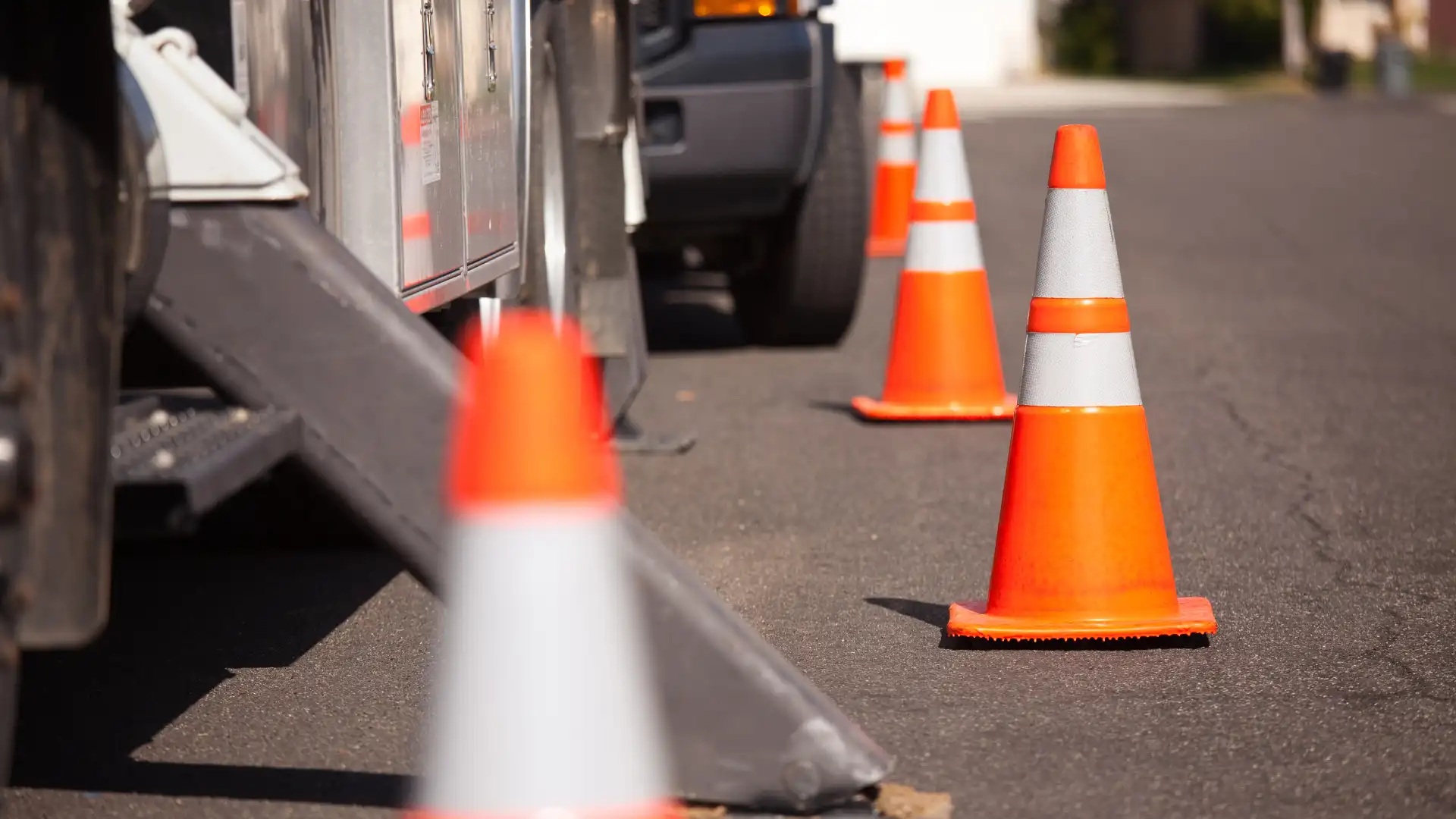 Orange traffic cones placed on road for safety.
